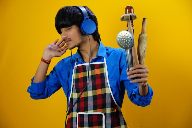 Joven escuchando música en la imagen de la cocina bg aislado