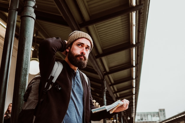 Un joven esperando en la estación de tren.