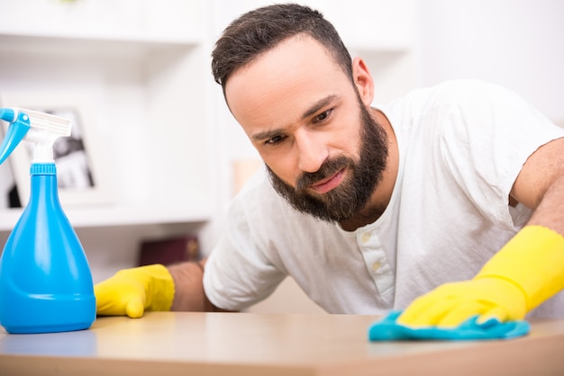 Joven está haciendo algunos trabajos de limpieza en la casa.