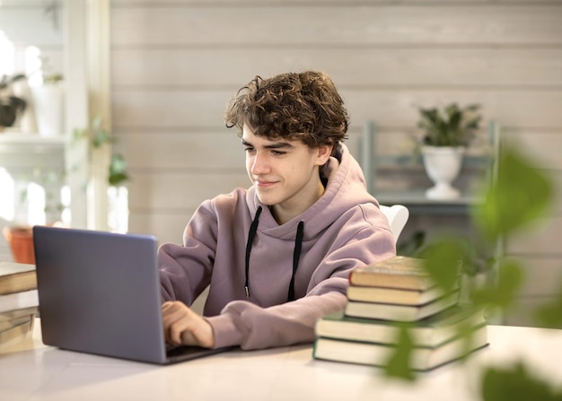 joven estudiante estudiando en casa mirando una laptop