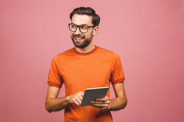 Joven feliz en situación casual y usando tableta