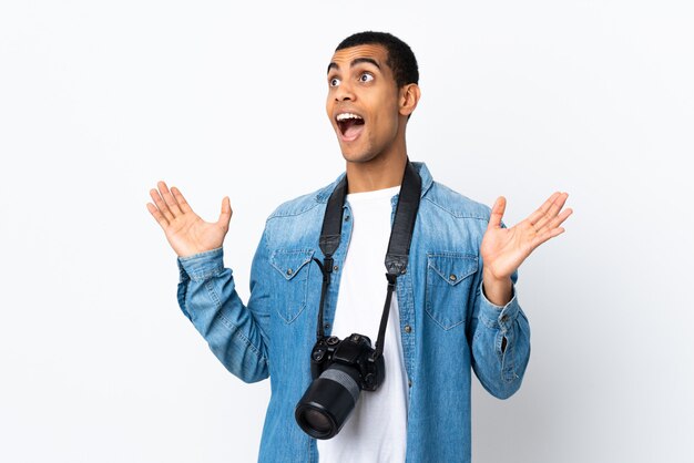 Joven fotógrafo afroamericano hombre sobre pared blanca aislada con expresión facial sorpresa