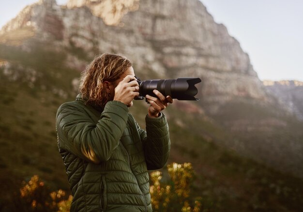 Joven fotógrafo haciendo clic en la foto de la cámara dslr