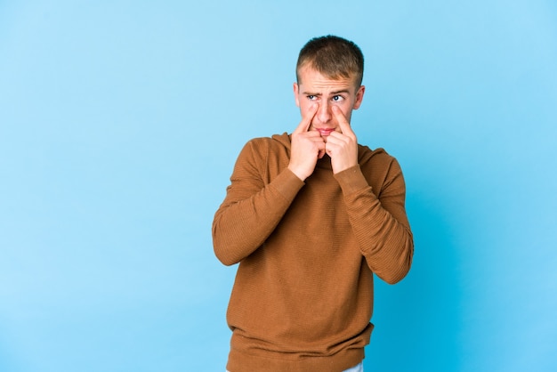 Joven guapo caucásico llorando, descontento con algo, concepto de agonía y confusión.