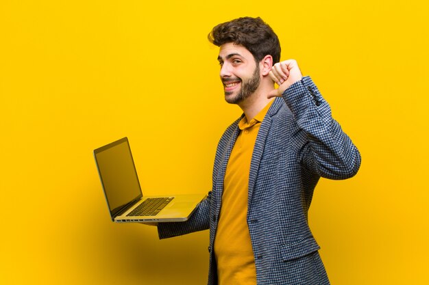 Joven guapo con un ordenador portátil