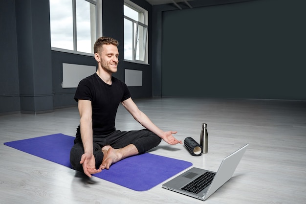 Joven haciendo yoga en una estera de yoga