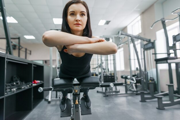 Joven hermosa mujer atlética morena haciendo ejercicios de fitness