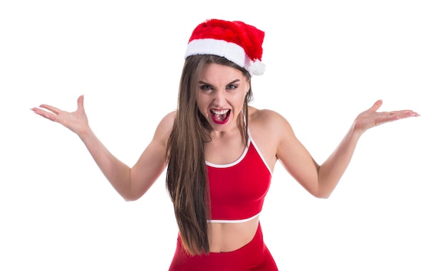 Joven hermosa mujer deportiva con sombrero de navidad sobre fondo blanco aislado loco y loco