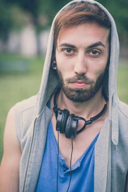 joven hipster hombre gay escuchando auriculares de música