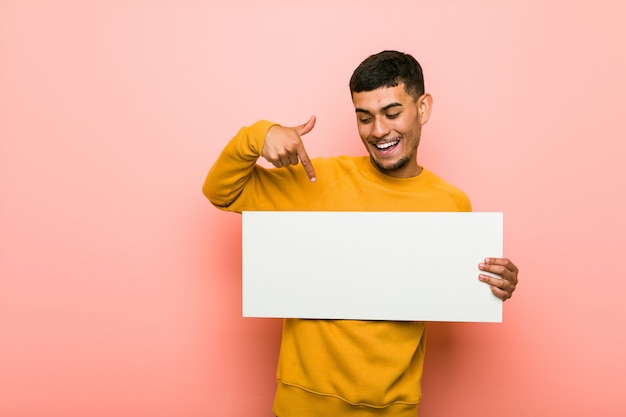 Joven hispano sosteniendo una pancarta