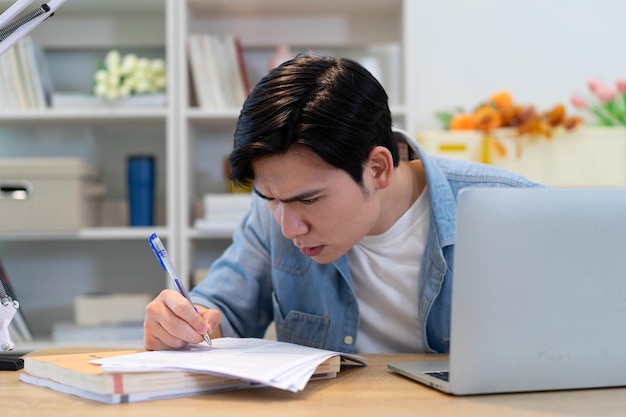 Joven hombre de negocios asiático trabajando en casa