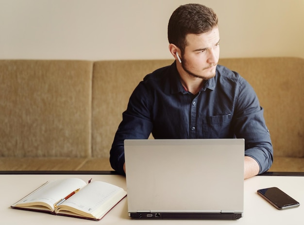 Joven hombre de negocios trabajando con computadora remotamente