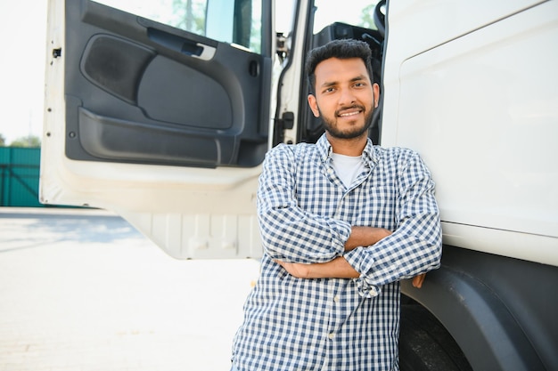 Joven indio de pie junto a su camión El concepto de transporte de mercancías