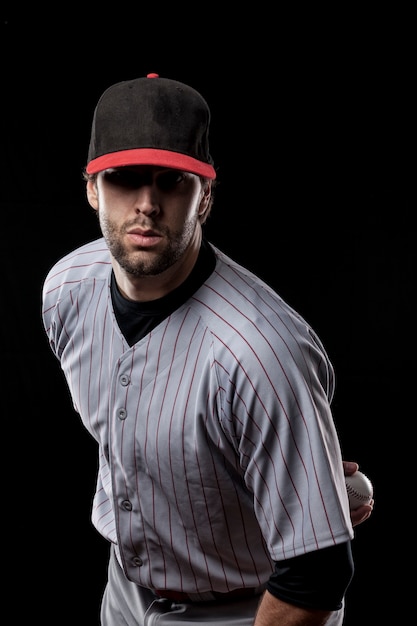 Foto joven jugador de béisbol con una gorra negra