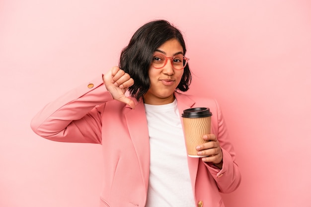 Joven latina sosteniendo café para llevar aislado sobre fondo rosa se siente orgullosa y segura de sí misma, ejemplo a seguir.