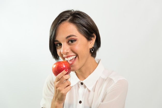 Joven latinoamericana comiendo una manzana feliz