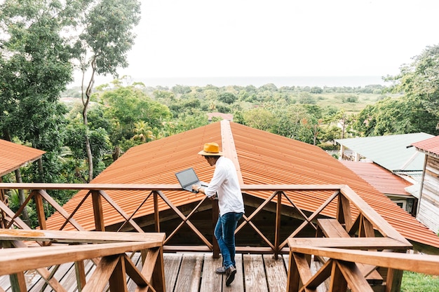 Joven latinoamericano que trabaja en un concepto de viajes y honduras para computadoras portátiles