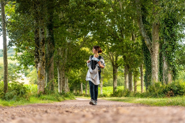 Una joven madre con su bebé en el bosque de Broceliande, un bosque místico francés ubicado en el departamento de Ille et Vilaine, Bretaña, cerca de Rennes. Francia