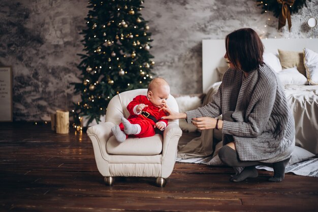 Joven madre con su bebé en Navidad