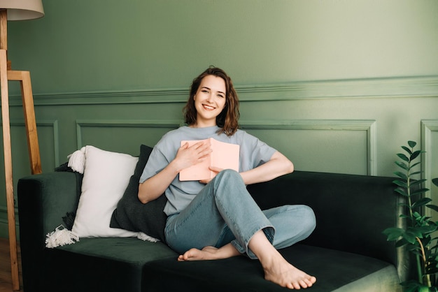 Foto una joven de mediana edad sonriente agarra un libro a su pecho