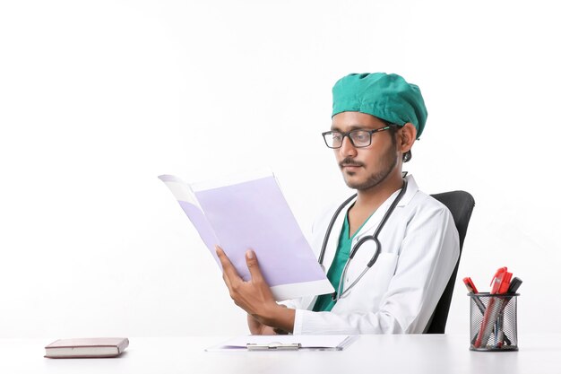 Joven médico indio comprobando el archivo en la clínica