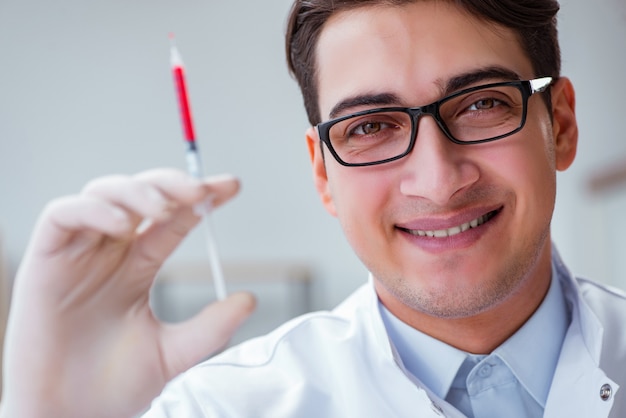 Joven médico con la jeringa