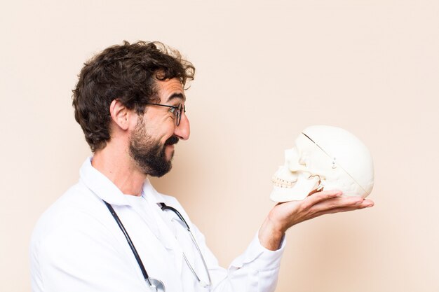 Joven médico y un modelo de cráneo humano