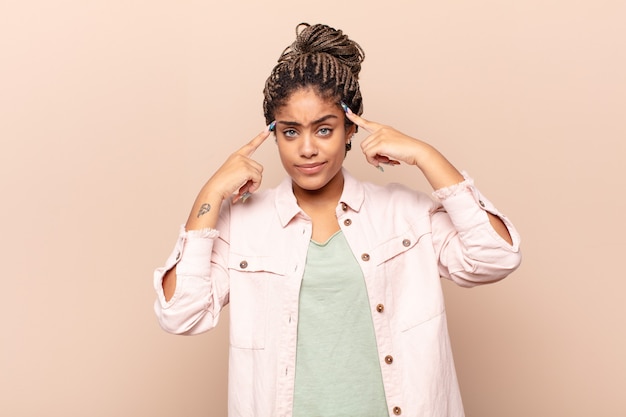 Joven mujer afro con mirada seria y concentrada