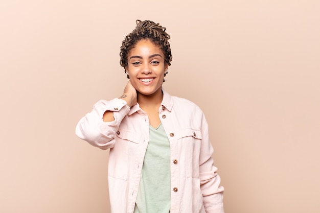 Joven mujer afro riendo alegremente y con confianza con una sonrisa informal, feliz y amigable