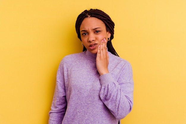 Joven mujer afroamericana que tiene un fuerte dolor de dientes, dolor de muelas.