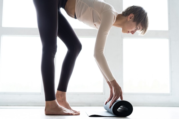 Joven mujer atractiva sonriente practicando yoga