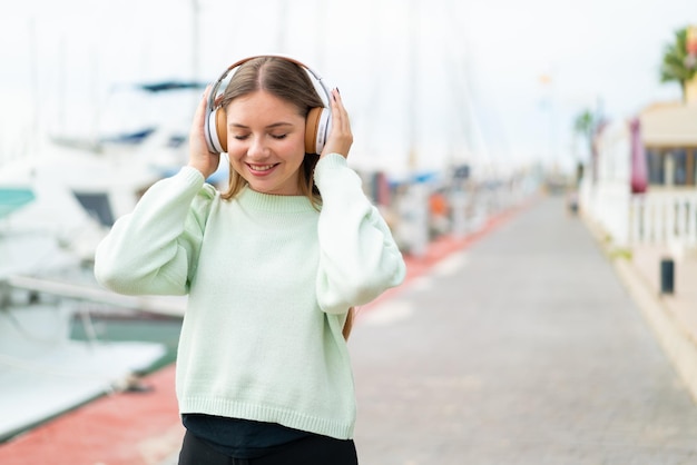 Joven mujer bonita rubia escuchando música