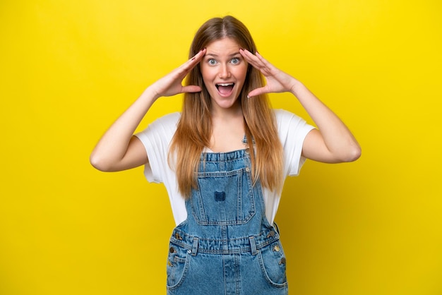 Joven mujer caucásica aislada sobre fondo amarillo con expresión de sorpresa