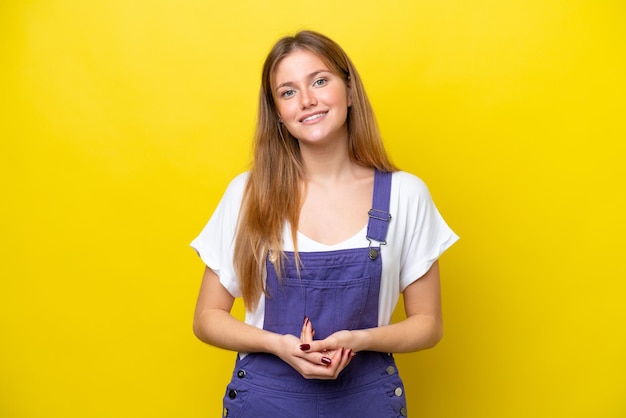 Joven mujer caucásica aislada sobre fondo amarillo riendo