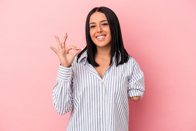 Joven mujer caucásica con un brazo aislado sobre fondo rosa alegre y confiado mostrando gesto ok.