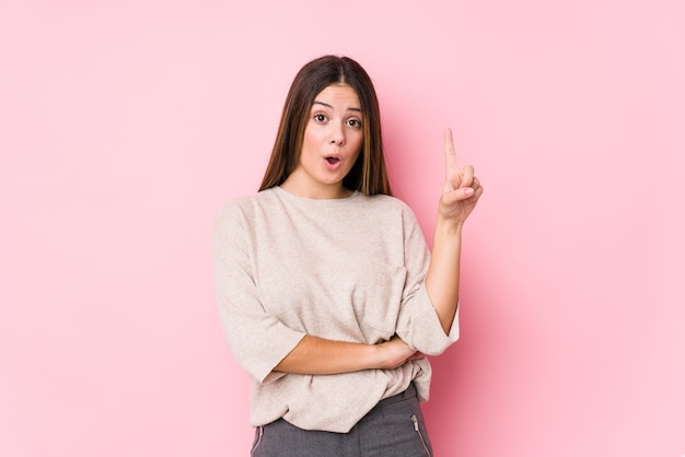 Joven mujer caucásica posando aislada con una gran idea, concepto de creatividad.