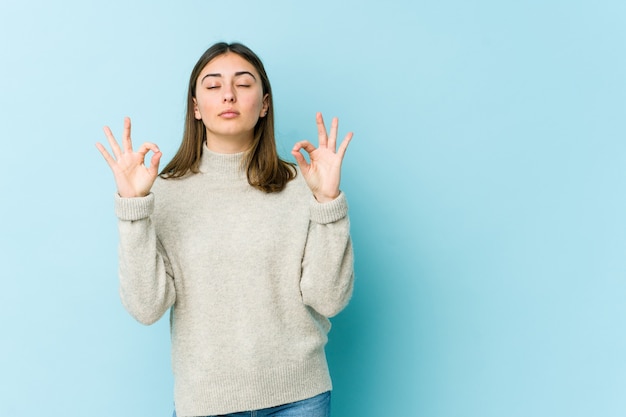 Joven mujer caucásica se relaja haciendo meditación