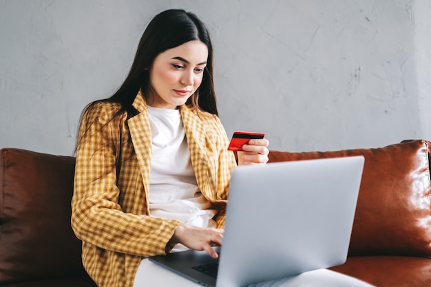 Joven mujer caucásica con tarjeta de crédito