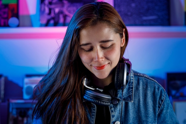 Joven mujer dj latina mezclando msica en una tienda de discos de vinilo