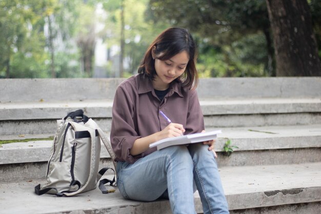 Joven mujer estudiando en el parque