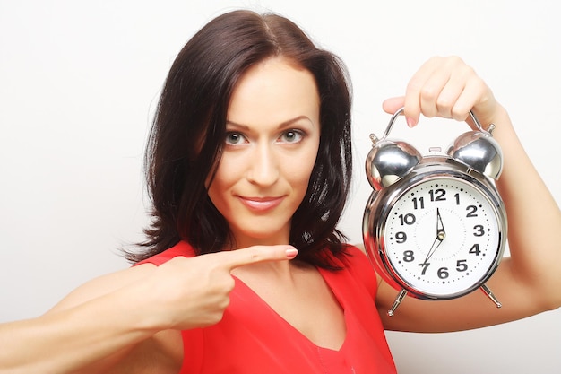 Joven mujer feliz con despertador