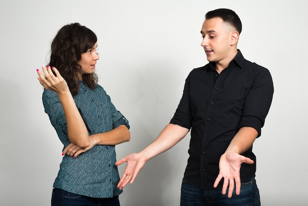 joven y mujer joven como pareja juntos y enamorados contra la pared blanca