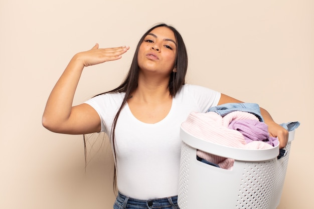 Foto joven mujer latina que se siente estresada, ansiosa, cansada y frustrada, tirando del cuello de la camisa, luciendo frustrada con el problema