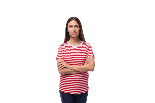 Foto joven mujer morena con una camiseta de rayas rojas y blancas en un fondo blanco con espacio de copia