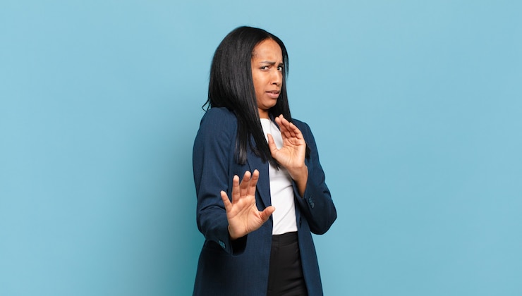 Foto joven mujer negra sintiéndose disgustada y con náuseas, alejándose de algo desagradable, maloliente o apestoso, diciendo asco. concepto de negocio