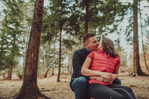 Joven pareja besándose en el bosque