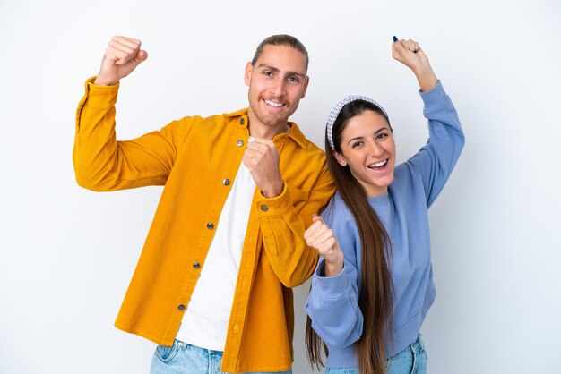 Foto joven pareja caucásica aislada de fondo blanco celebrando una victoria