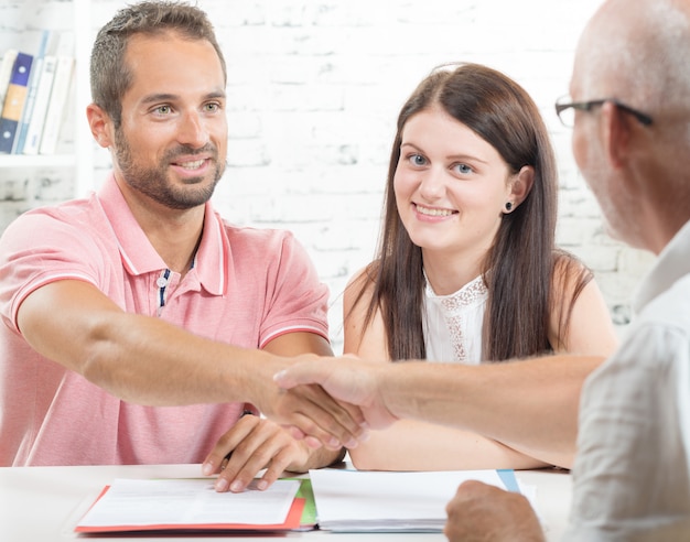 Foto una joven pareja firma un contrato