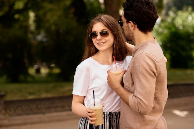 Joven pareja hermosa divertirse y caminar por las calles de la ciudad y tomar café