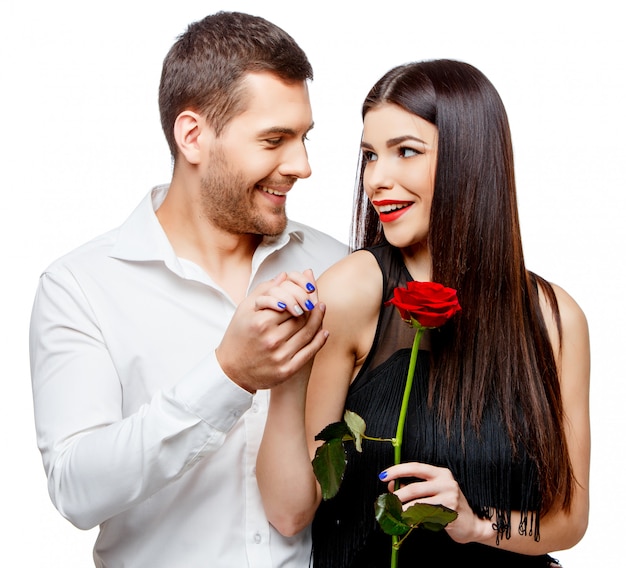 Joven pareja hermosa con flores en blanco